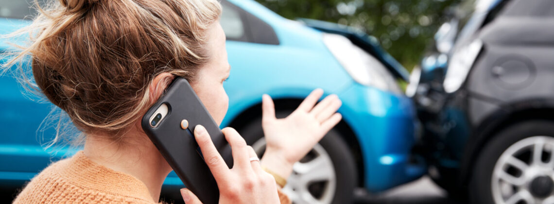 Female Motorist Involved In Car Accident Calling Insurance Company Or Recovery Service