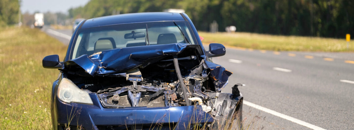 Dumped crashed car after traffic accident parked on highway roadside