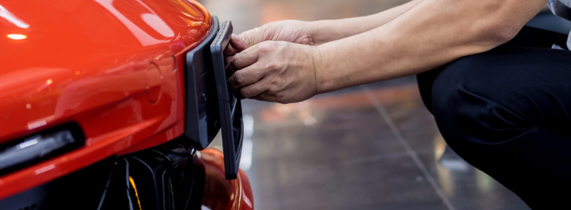 Technician changing car plate number in service center.