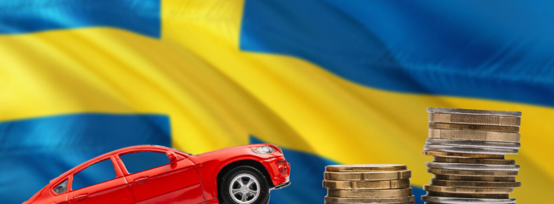 Sweden savings concept. Money for new automobile, toy car and coin piles standing on national flag background. Copy space for text.