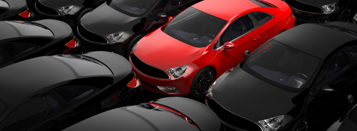 red car surrounded by black cars