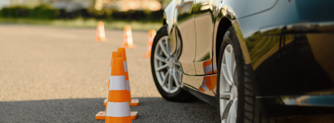 Car and traffic cones, driving school concept